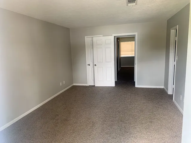 a view of an empty room and closet area