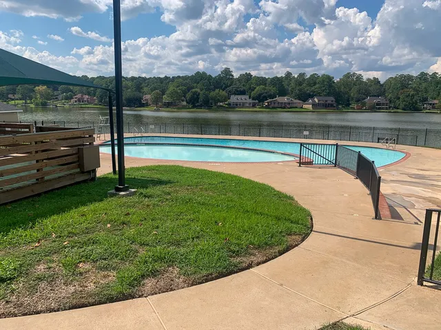 a view of a swimming pool with a yard