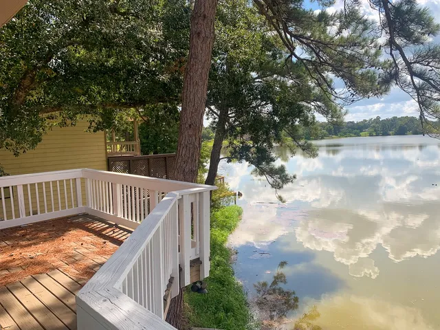 a view of balcony with wooden floor and fence