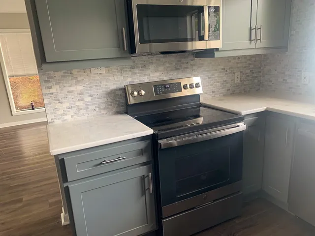 a stove top oven sitting inside of a kitchen