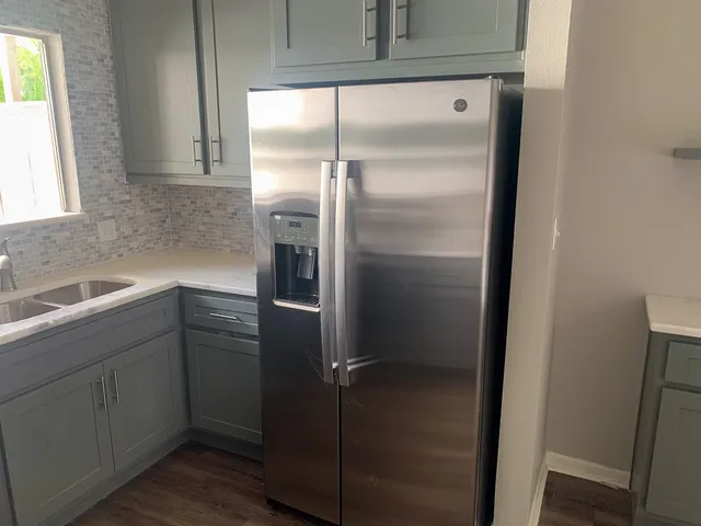 a kitchen with a refrigerator and a sink