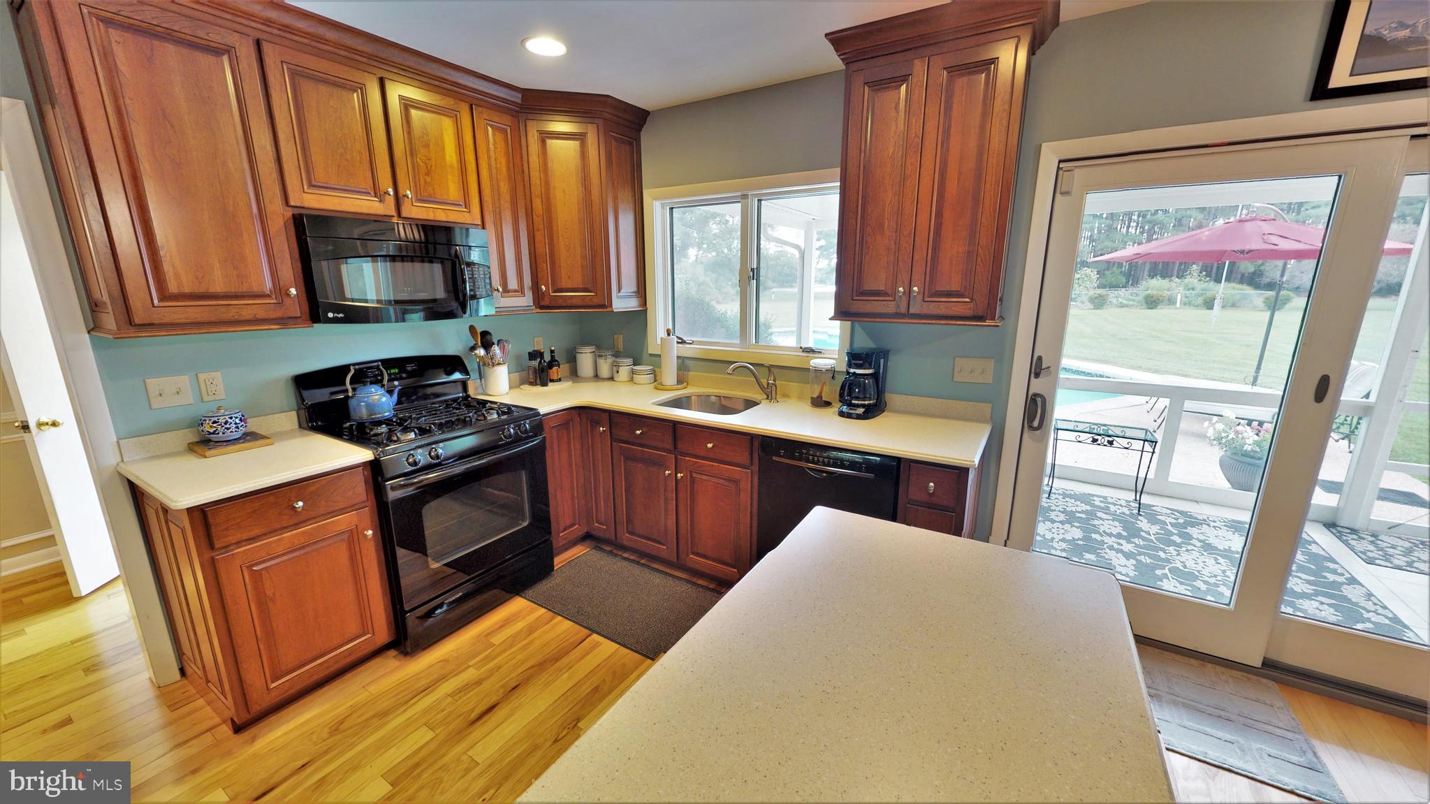 25972 Goose Neck Road Royal Oak, MD 21662 - Photo 17 of 58 Kitchen leads to screened porch with pool view