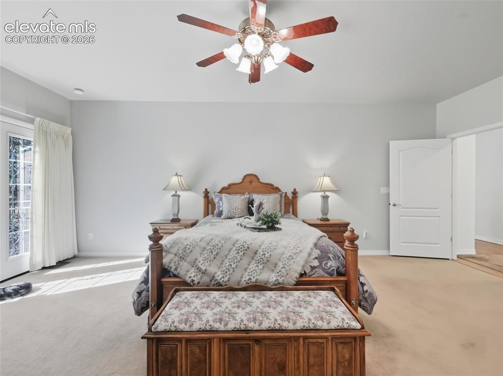 12855 Murphy Road Elbert, CO 80106 - Photo 15 of 50 a bedroom with a bed and a chandelier fan