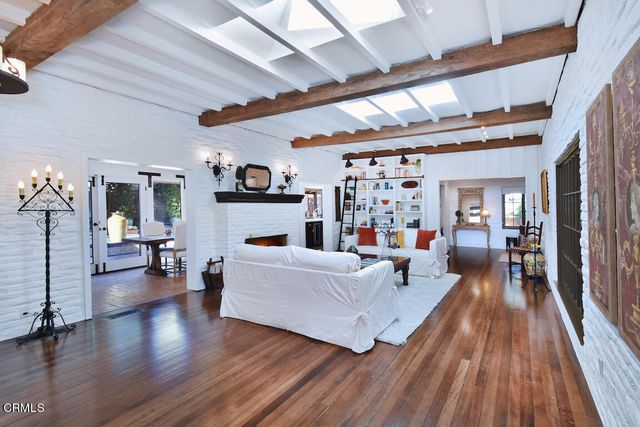 a view of a livingroom with furniture and hardwood floor