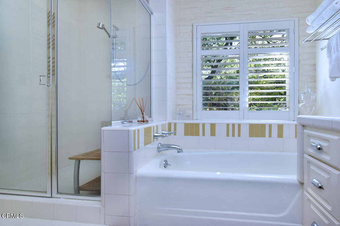 4727 Libbit Avenue Encino, CA 91436 - Photo 42 of 47 a bathroom with a bathtub and a window
