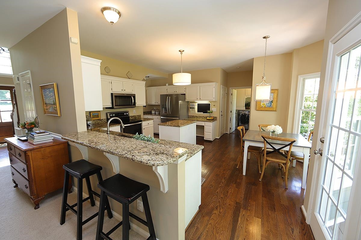 5152 Fairmead Circle Raleigh, NC 27613 - Photo 8 of 25 Notice the Granite, the Bar and Stainless Appliances Fabulous Functional Eat In Kitchen