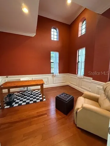 a living room with furniture a rug and a window