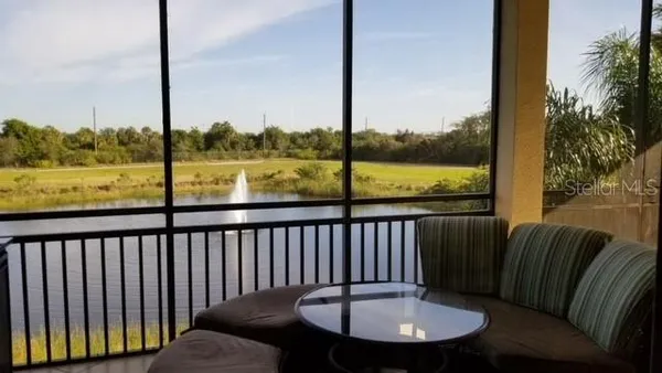 a view of a balcony with a table and chairs
