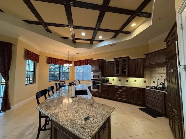 a large kitchen with lots of counter space a sink and appliances