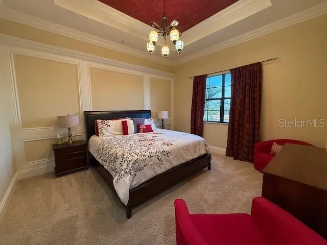 a bedroom with a bed couch and window