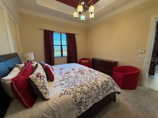 a bedroom with a bed dresser and a window