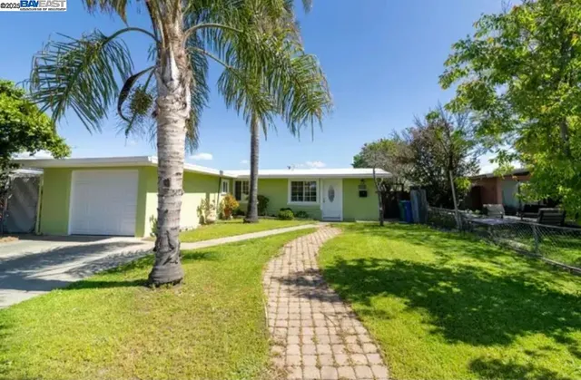 a front view of house with yard and green space