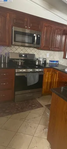 a stove top oven sitting inside of a kitchen