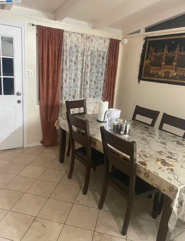 a dining room with furniture and window