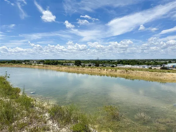 a view of a water pond with an outdoor seating