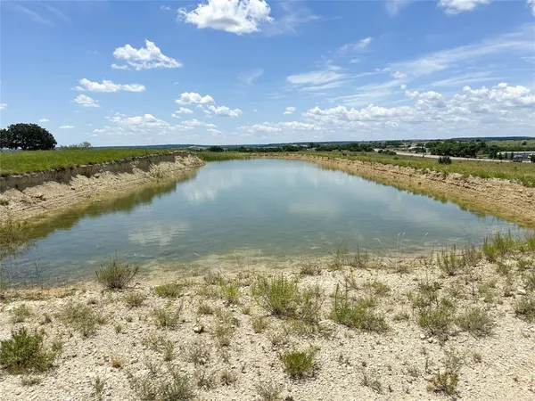 a view of a field with an ocean