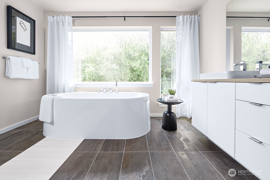 3912 199th Place Southeast Bothell, WA 98012 - Photo 10 of 10 a white bath tub sitting in a bathroom next to a window
