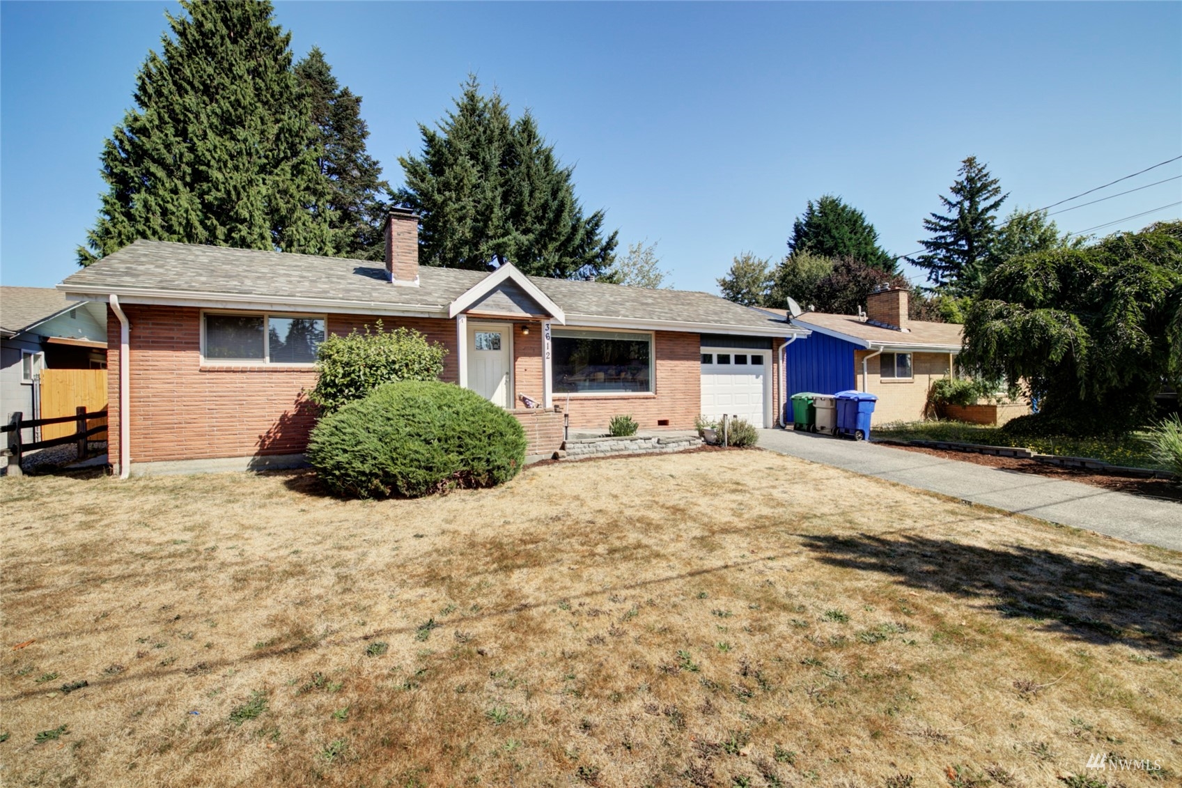 3612 Northeast 9th Street Renton, WA 98056 - Photo 1 of 23 a front view of a house with a yard and garage