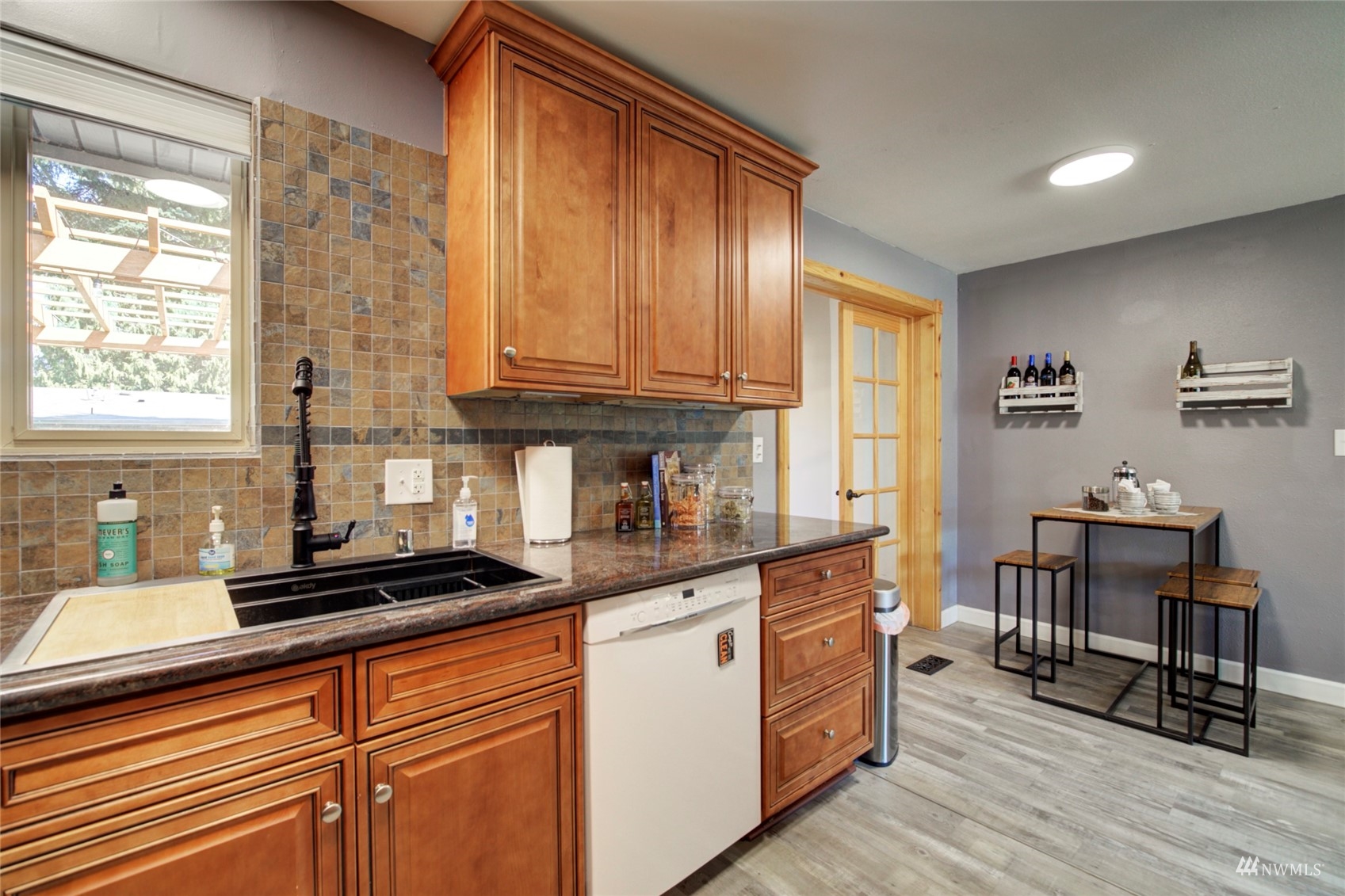 3612 Northeast 9th Street Renton, WA 98056 - Photo 13 of 23 a kitchen with granite countertop a stove a sink and wooden cabinets