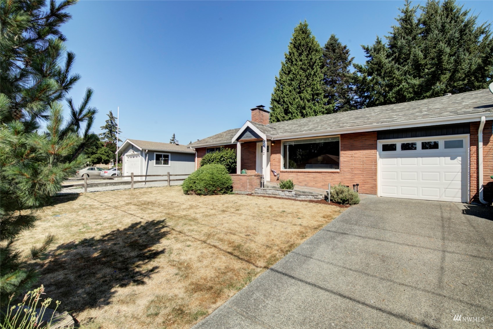 3612 Northeast 9th Street Renton, WA 98056 - Photo 2 of 23 a front view of a house with a yard and garage