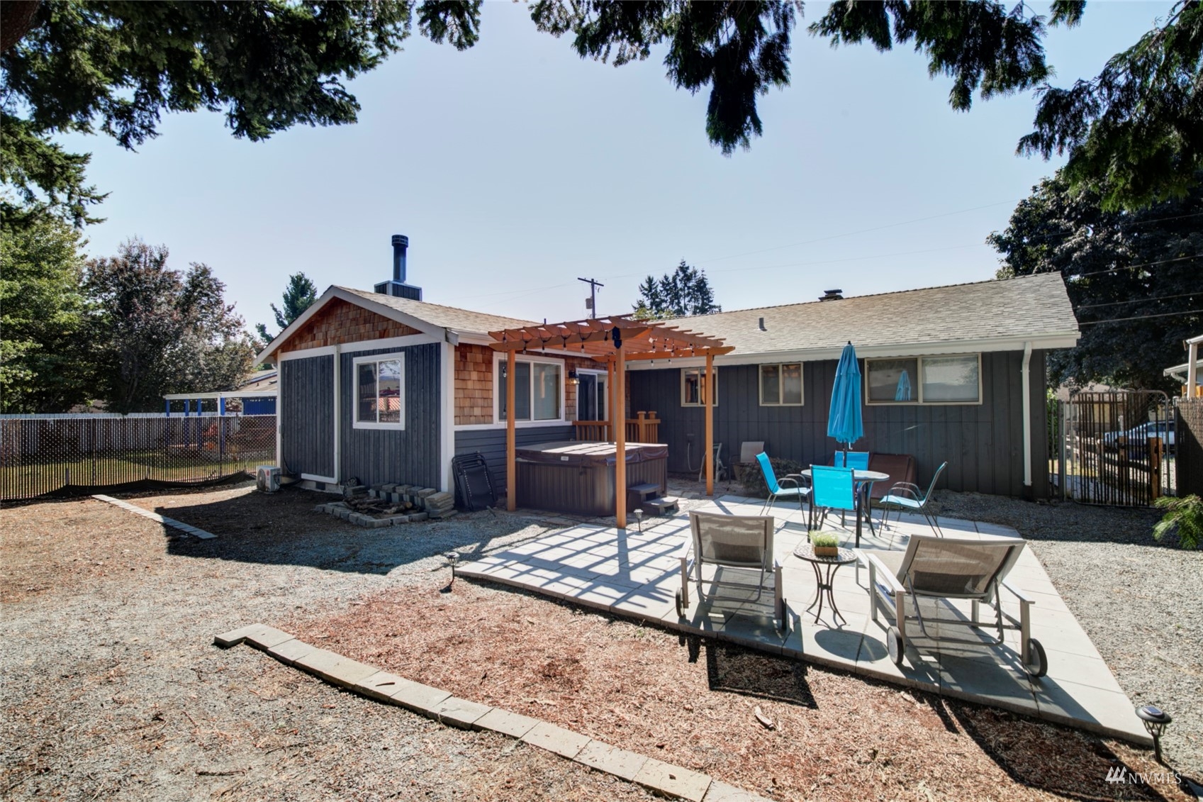 3612 Northeast 9th Street Renton, WA 98056 - Photo 23 of 23 a patio with couches a table and chairs with wooden fence