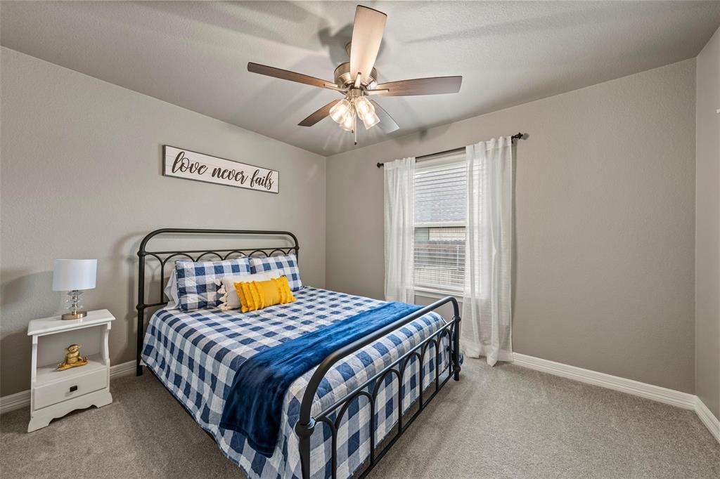 828 Agile Street Hewitt, TX 76643 - Photo 19 of 30 a bedroom with a bed and a chandelier