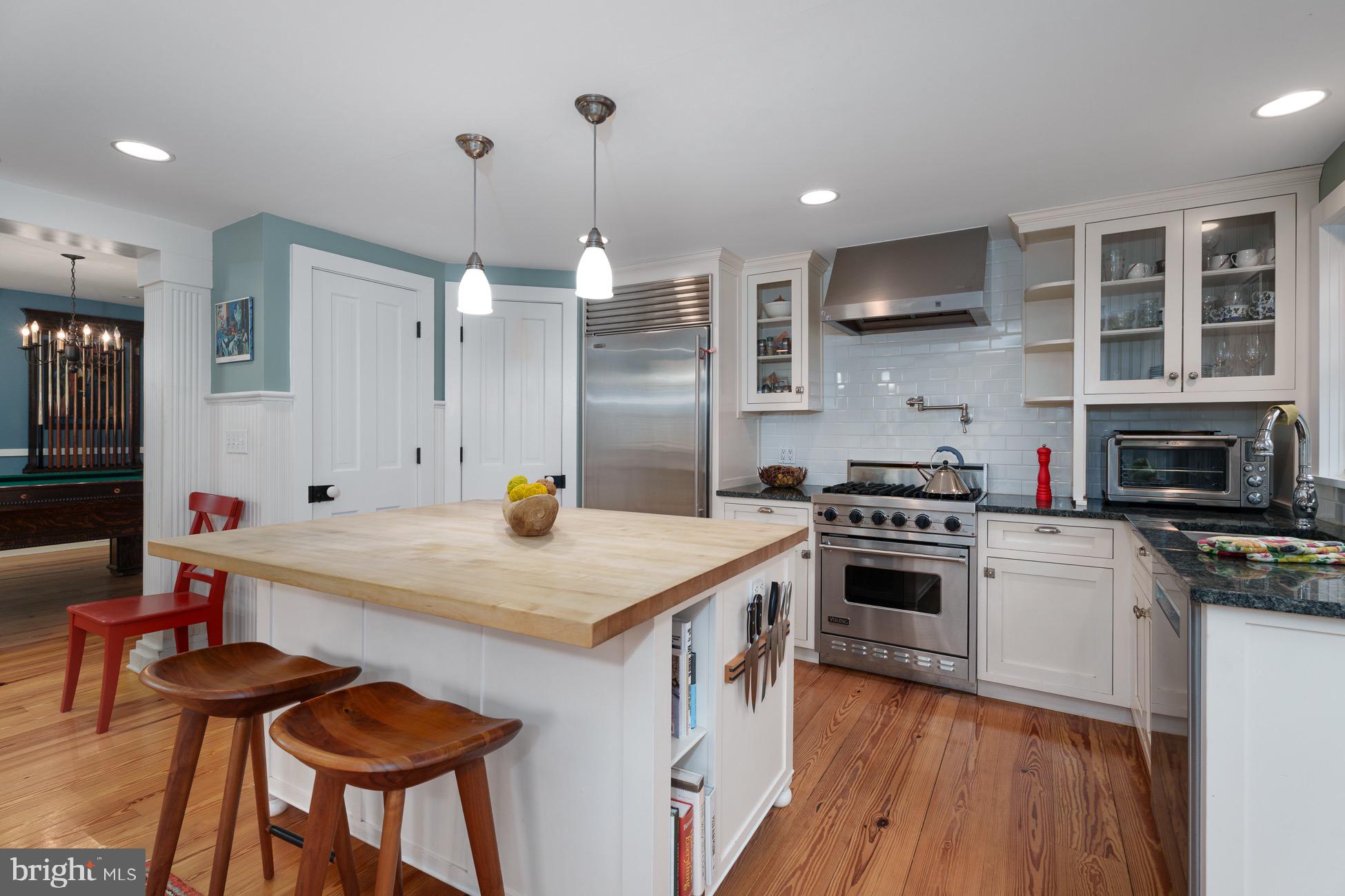 29 Chestnut Street Princeton, NJ 08542 - Photo 8 of 26 a kitchen with stainless steel appliances a stove a sink a kitchen island with wooden cabinets and chair