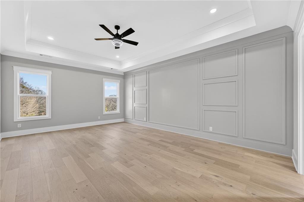 405 Thunder Road Buford, GA 30518 - Photo 81 of 104 wooden floor in an empty room with a ceiling fan