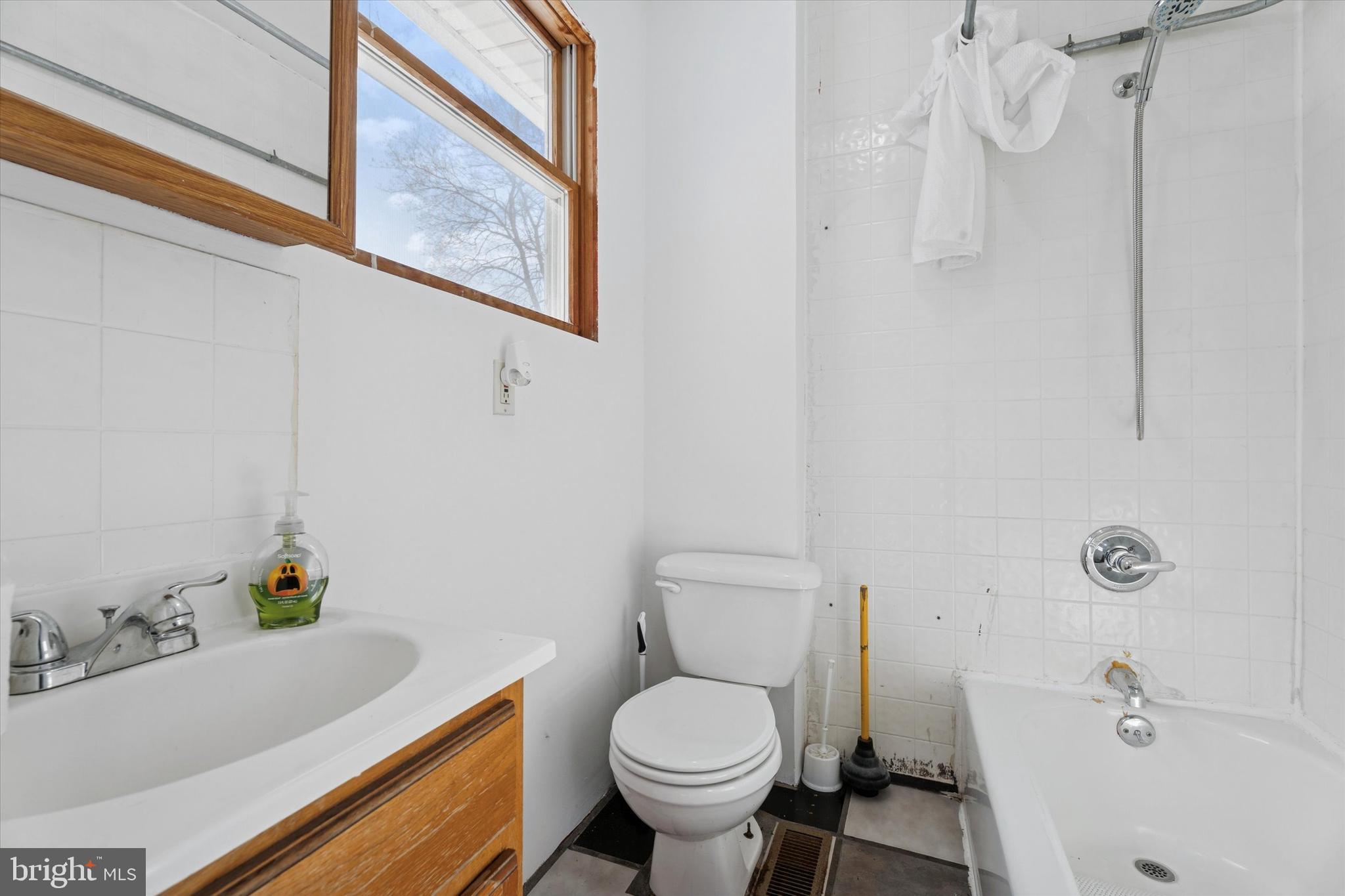 2943 East Walnut Street Colmar, PA 18915 - Photo 19 of 24 a white toilet sitting next to a bathroom sink