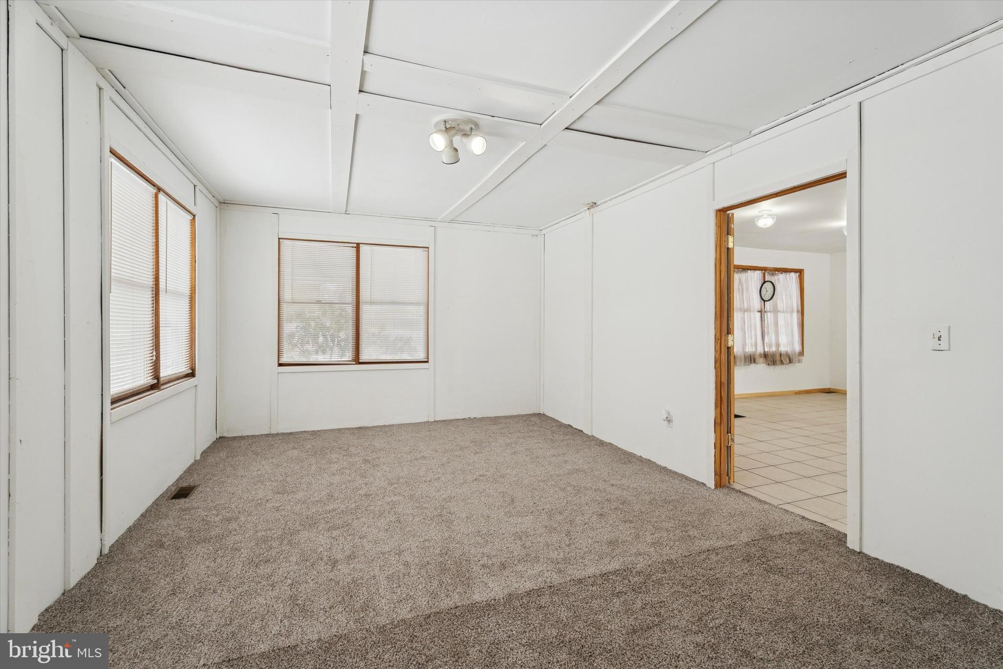 2943 East Walnut Street Colmar, PA 18915 - Photo 6 of 24 an empty room with windows and chandelier fan