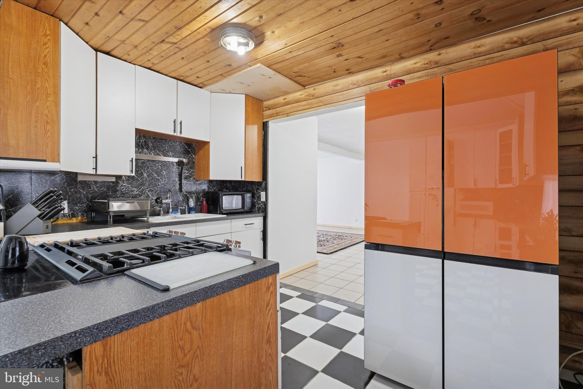 2943 East Walnut Street Colmar, PA 18915 - Photo 7 of 24 a kitchen with stainless steel appliances granite countertop a stove a sink a refrigerator white cabinets and wooden floor