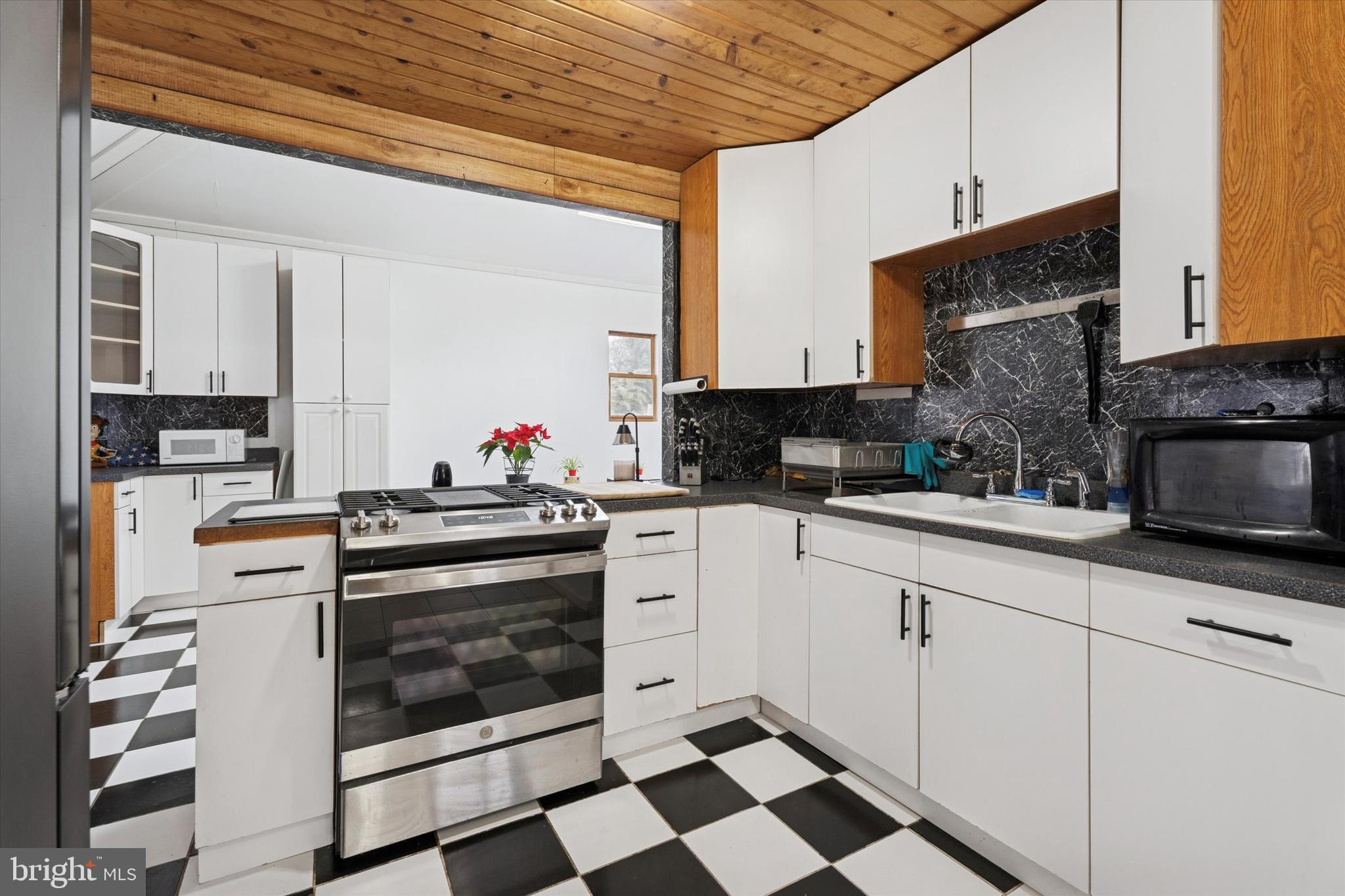 2943 East Walnut Street Colmar, PA 18915 - Photo 9 of 24 a kitchen with stainless steel appliances a stove a sink and a microwave