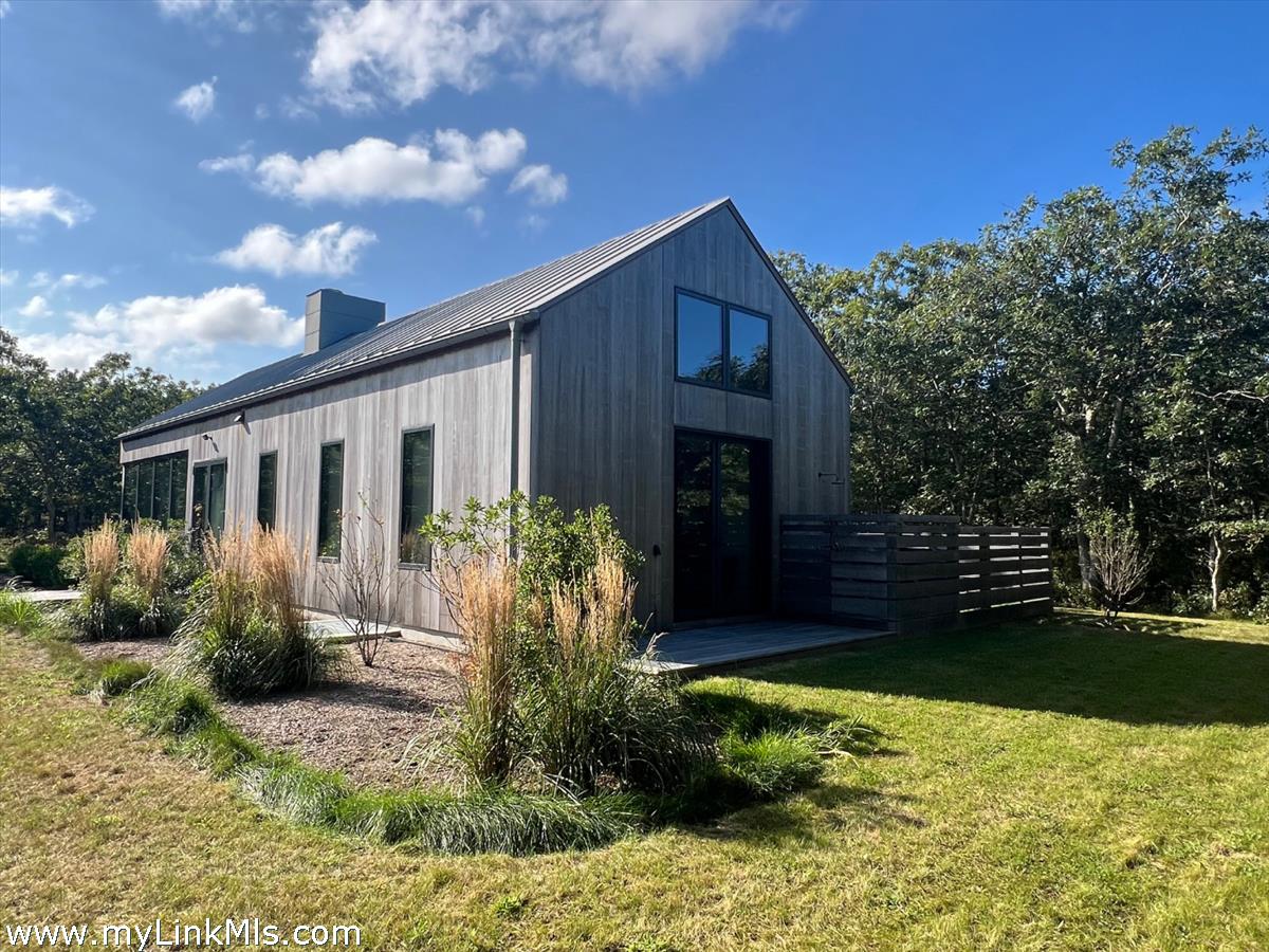 4 Jacob's Neck Road Edgartown, MA 02539 - Photo 4 of 20 a front view of house with yard and trees in the background