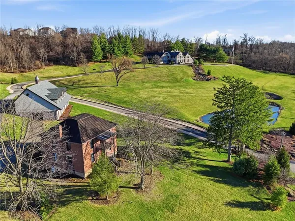 an aerial view of a house with a yard and lake view