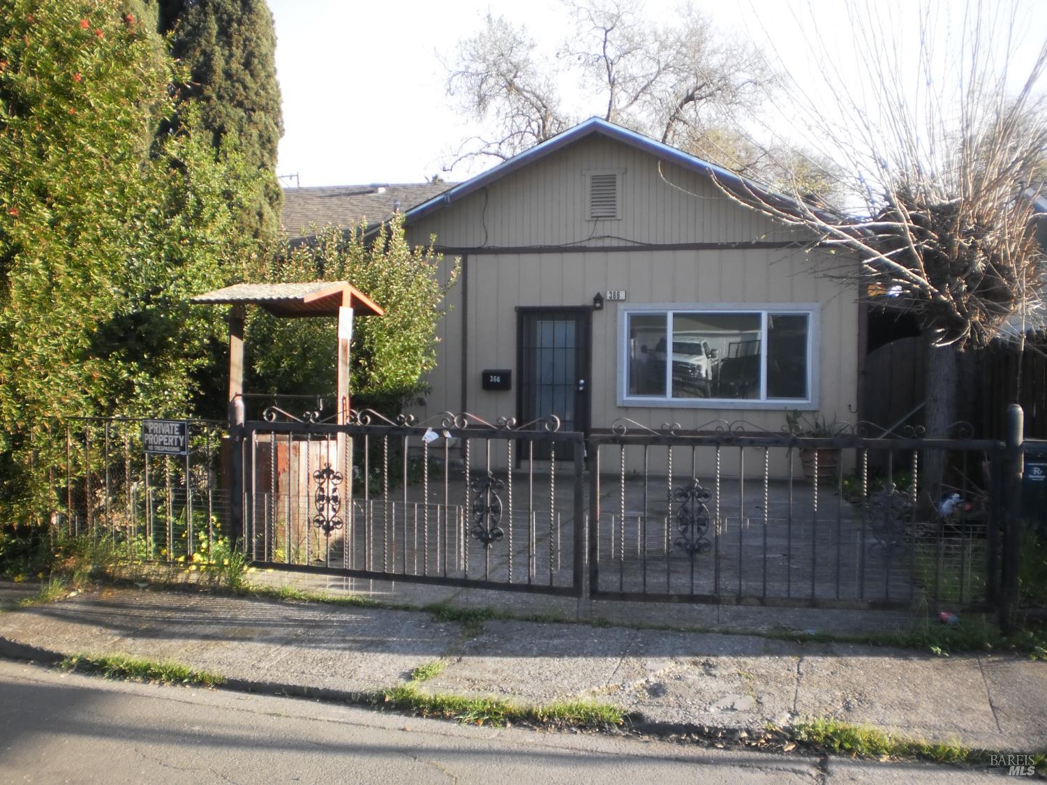 1911 Corby Avenue Santa Rosa, CA 95407 - Photo 5 of 19 a view of a brick house with large windows and a small yard