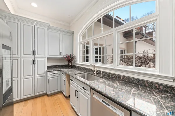 a kitchen with stainless steel appliances granite countertop a sink and a stove