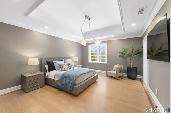 a spacious bedroom with a bed and large windows