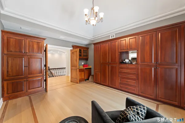 a livingroom with furniture cabinet and a chandelier