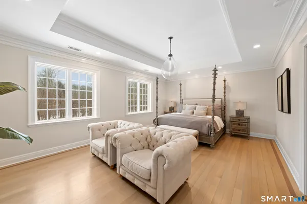 a spacious bedroom with a bed couch and a window