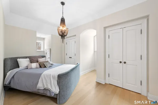 a bedroom with a bed and a chandelier