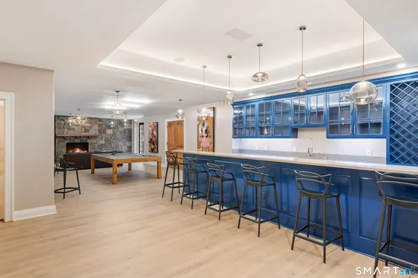 a open kitchen with stainless steel appliances granite countertop a sink table and chairs