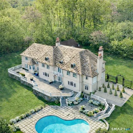 a view of a house with swimming pool and furniture