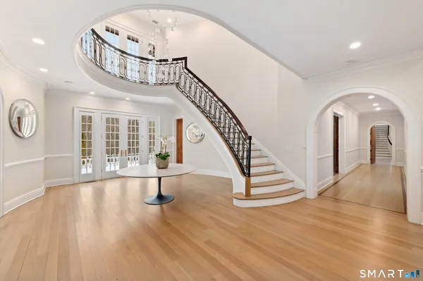 a view of entryway and hall with wooden floor