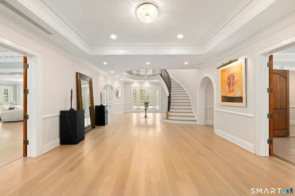 a view of a living room and kitchen with furniture wooden floor and windows