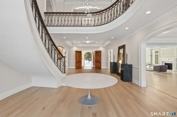 a view of a livingroom with furniture wooden floor and staircase