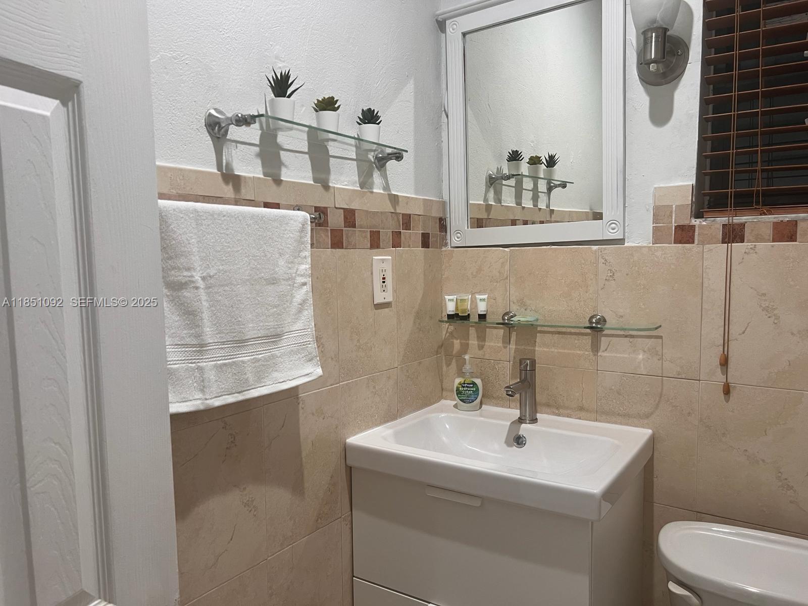 1721 Southwest 24th Terrace Miami, FL 33145 - Photo 68 of 80 a bathroom with a sink a toilet and mirror