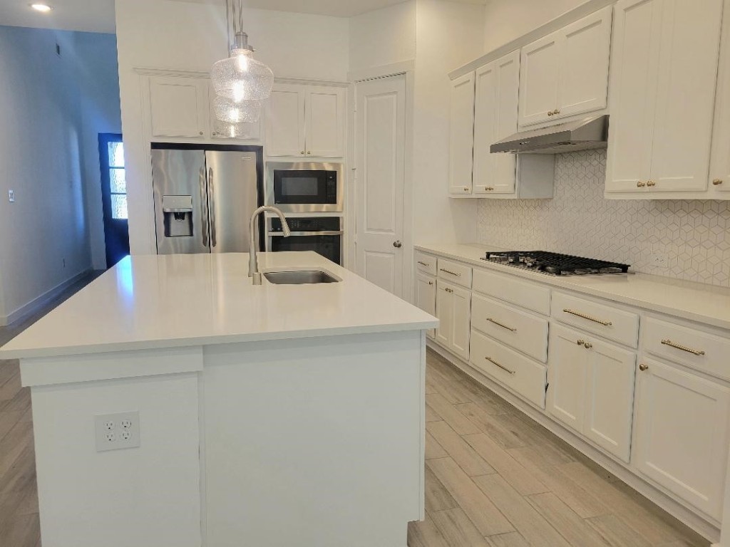 17351 Merigold Hts Drive Conroe, TX 77302 - Photo 10 of 49 a kitchen with cabinets appliances a sink and a counter top space