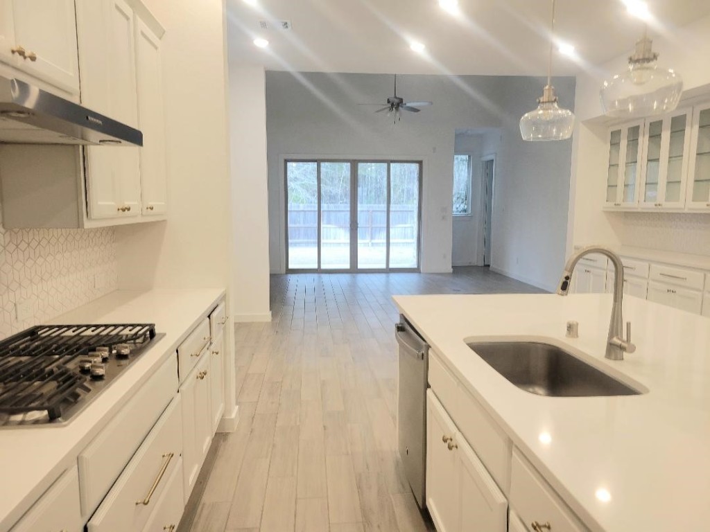 17351 Merigold Hts Drive Conroe, TX 77302 - Photo 12 of 49 a kitchen with a sink a stove and cabinets
