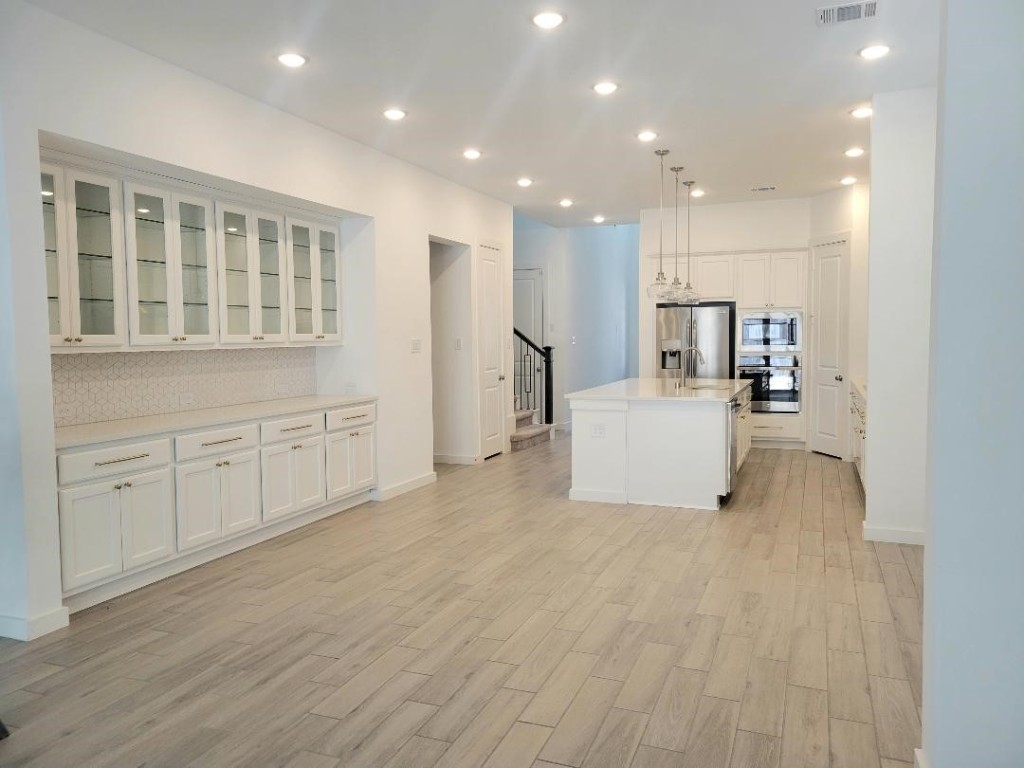 17351 Merigold Hts Drive Conroe, TX 77302 - Photo 13 of 49 a view of an empty room with a kitchen