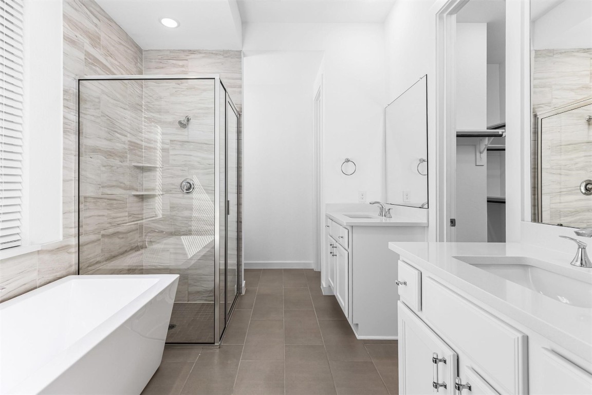 17351 Merigold Hts Drive Conroe, TX 77302 - Photo 19 of 49 a bathroom with a tub sink and mirror